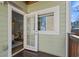 Exterior view of a balcony with a wood floor, railing, exterior access door, and a small window at 735 Ponce De Leon Pl Ne, Atlanta, GA 30306