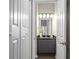 Small bathroom featuring granite counters, overhead vanity lighting, cabinet storage, and modern fixtures at 735 Ponce De Leon Pl Ne, Atlanta, GA 30306