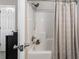Bright bathroom featuring a tub with shower and grey curtain at 735 Ponce De Leon Pl Ne, Atlanta, GA 30306