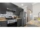 Well-appointed kitchen with granite countertops, stainless steel appliances, and stylish tile backsplash at 735 Ponce De Leon Pl Ne, Atlanta, GA 30306