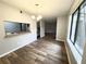 Dining area with wood-look floors, updated chandelier and a view into the kitchen at 925 Seasons Pkwy, Norcross, GA 30093