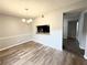 Dining room featuring wood-look floors, modern lighting, and convenient pass-through to the kitchen at 925 Seasons Pkwy, Norcross, GA 30093