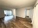 Open living room featuring wood-look flooring and a sliding glass door to a sunroom at 925 Seasons Pkwy, Norcross, GA 30093