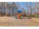 Community playground with colorful equipment, surrounded by trees and open space at 925 Seasons Pkwy, Norcross, GA 30093