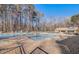 Community pool with lounge chairs and umbrellas on a sunny day at 925 Seasons Pkwy, Norcross, GA 30093