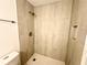Updated tile shower with bronze fixtures and built-in niche at 925 Seasons Pkwy, Norcross, GA 30093