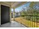 Balcony view with a black metal railing overlooking grassy area and mature trees at 1150 Collier Nw Rd # J11, Atlanta, GA 30318