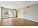 Light-filled bedroom with wood-look flooring and balcony access via sliding glass doors at 1150 Collier Nw Rd # J11, Atlanta, GA 30318