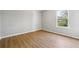 Cozy bedroom featuring wood flooring and a bright window at 1150 Collier Nw Rd # J11, Atlanta, GA 30318