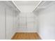 Walk-in closet with built-in adjustable wire shelving and wood-look flooring at 1150 Collier Nw Rd # J11, Atlanta, GA 30318