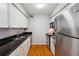 Modern kitchen with stainless steel appliances, granite countertops, and ample cabinet space at 1150 Collier Nw Rd # J11, Atlanta, GA 30318