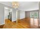 Open-concept living area with hardwood floors, stainless steel appliances, and patio access at 1150 Collier Nw Rd # J11, Atlanta, GA 30318