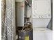 Utility closet featuring a stacked washer/dryer and hot water heater at 1150 Collier Nw Rd # J11, Atlanta, GA 30318
