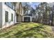 Scenic backyard featuring a grassy lawn, mature trees, and an exterior view of the home's architectural details at 128 Owens Mill Pl, Canton, GA 30115