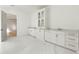 A stylish bathroom with marble floors, modern vanity, and doorway access, showcasing contemporary design elements at 128 Owens Mill Pl, Canton, GA 30115