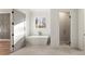 Bright bathroom featuring a modern tub, tiled shower, and neutral decor at 128 Owens Mill Pl, Canton, GA 30115