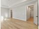 Bright bedroom showcasing a tray ceiling and doorway access, complemented by the warm tones of the hardwood flooring at 128 Owens Mill Pl, Canton, GA 30115