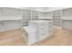 Walk-in closet offering ample storage with shelving and drawers, complemented by bright light hardwood flooring at 128 Owens Mill Pl, Canton, GA 30115