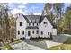 Beautiful two-story home with black trim windows, neutral paint, and a spacious driveway at 128 Owens Mill Pl, Canton, GA 30115