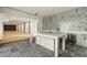 Flex room with gray slate flooring, wet bar with backsplash, and open floor plan at 128 Owens Mill Pl, Canton, GA 30115