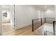 Hallway featuring hardwood floors, modern railing, and lots of natural light at 128 Owens Mill Pl, Canton, GA 30115