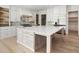 Elegant kitchen with a large island, custom cabinets, and a tile backsplash at 128 Owens Mill Pl, Canton, GA 30115