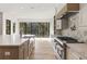 Kitchen with a large island, custom cabinets, designer backsplash, and stainless steel appliances at 128 Owens Mill Pl, Canton, GA 30115