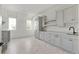 Bright laundry room with custom cabinets, counter space, and modern finishes at 128 Owens Mill Pl, Canton, GA 30115