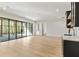 Bright living room with light hardwood floors, black-framed windows and a convenient wet bar for entertaining at 128 Owens Mill Pl, Canton, GA 30115