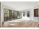 Sun-drenched living room with hardwood floors and expansive windows offering scenic wooded views at 128 Owens Mill Pl, Canton, GA 30115