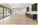 Bright living room with light hardwood floors, black-framed windows and a convenient wet bar for entertaining at 128 Owens Mill Pl, Canton, GA 30115