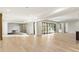 Spacious room with light hardwood floors and expansive windows offering abundant natural light and backyard views at 128 Owens Mill Pl, Canton, GA 30115