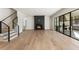 Open-concept living room featuring a fireplace, hardwood floors, and access to the porch at 128 Owens Mill Pl, Canton, GA 30115