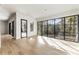 Open living space with hardwood floors, large windows, and a stylish black-framed glass door at 128 Owens Mill Pl, Canton, GA 30115