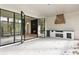 Covered patio featuring an outdoor kitchen, wood-burning fireplace, and black-framed glass doors at 128 Owens Mill Pl, Canton, GA 30115