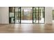 Indoor-outdoor living with expansive doors leading to a covered patio and outdoor grill area at 128 Owens Mill Pl, Canton, GA 30115