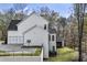 Bright home featuring a two-car garage, side yard, and black framed windows at 128 Owens Mill Pl, Canton, GA 30115
