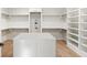 Spacious walk-in closet featuring an island, built-in shelving, and ample storage space at 128 Owens Mill Pl, Canton, GA 30115