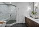 Modern bathroom with a walk-in shower, double vanity with wood cabinets, and contemporary fixtures at 1919 Repose Dr, Chamblee, GA 30341