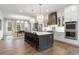 Modern kitchen with a large island, stainless steel appliances, and open layout to dining and living areas at 1919 Repose Dr, Chamblee, GA 30341
