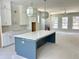 Spacious kitchen with island, modern lighting, and large windows providing lots of natural light at 1919 Repose Dr, Chamblee, GA 30341