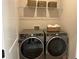 Efficient laundry room with modern washer and dryer units and overhead shelving at 1919 Repose Dr, Chamblee, GA 30341