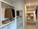 Organized walk-in closet with built-in shelving and ample storage for clothes and accessories at 1919 Repose Dr, Chamblee, GA 30341