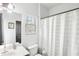 Bathroom with a toilet, vanity, sink, mirror and shower with a white patterned shower curtain at 2248 Newbury Oaks Dr, Lawrenceville, GA 30044