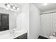 Bright bathroom featuring a vanity with modern fixtures and a shower with patterned curtain at 2248 Newbury Oaks Dr, Lawrenceville, GA 30044