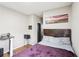 Bedroom with artwork, bed, desk, wood floors, and soft natural light at 2248 Newbury Oaks Dr, Lawrenceville, GA 30044