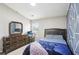 Comfortable bedroom featuring a dark wood dresser and a geometric patterned accent wall at 2248 Newbury Oaks Dr, Lawrenceville, GA 30044