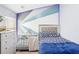 Cozy bedroom featuring a crib, geometric wall design, and ample natural light at 2248 Newbury Oaks Dr, Lawrenceville, GA 30044