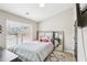 Cozy bedroom featuring a large window, bed with plush bedding, and a floor-length mirror at 2248 Newbury Oaks Dr, Lawrenceville, GA 30044