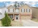 Charming two-story home featuring a brick-accented facade, neutral siding, and a well-manicured front yard at 2248 Newbury Oaks Dr, Lawrenceville, GA 30044